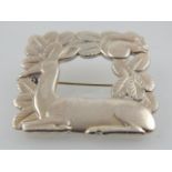 A sterling silver Danish brooch of square framed form, decorated with a deer and squirrel amongst