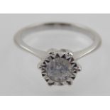 An 18 carat white gold solitaire diamond ring, set round cut stone of 0.64 carats.