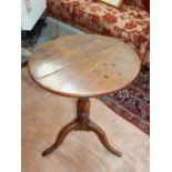 George III oak wine table, the circular top above a baluster support and tripod vase with pad feet,