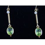 A pair of peridot and diamond set ear pendants,