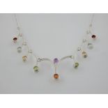 A silver and multi-gem necklace, set amethyst, topaz, and peridot.