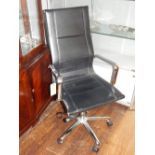 A contemporary black leather office chair, with polished chrome open arms.