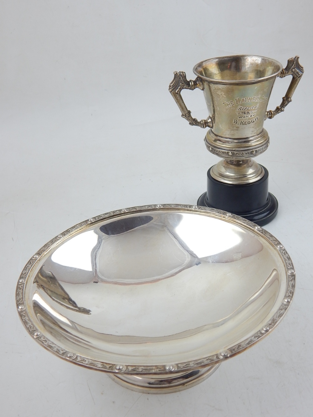 A George V circular Irish silver dish with embossed Celtic design border together with a later