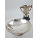 A George V circular Irish silver dish with embossed Celtic design border together with a later