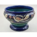 An unusual William Moorcroft circular bowl, decorated with exotic birds and stylised flowers,