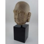 A Chinese early Ming Dynasty carved stone head of Lohan, with intricately shaped beard, brows and