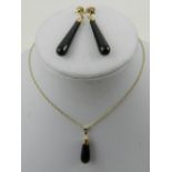 A 9 carat yellow gold and onyx drop pendant, suspended on a 9 carat yellow gold chain, together with