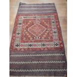 A Southern Russian rug/wall hanging, the central lozenge on a blue stylised foliate ground, with