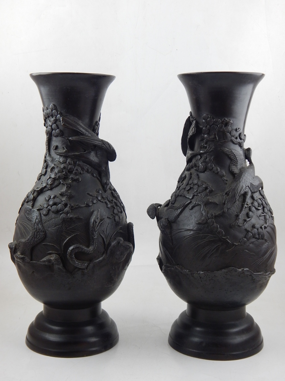 A pair of late 19th century Japanese Meiji period bronze vases, embossed decorated with snakes and