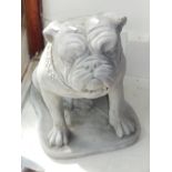 A pair of reconstituted stone ornaments modelled as seated bulldogs. H. 44cm