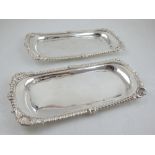 A pair of George III rectangular silver candle snuffer trays, with cast shell and gadrooned borders,