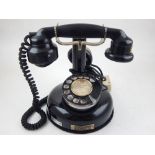 An early to mid 20th century French telephone, of pedestal type with a circular base incorporating