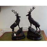 A pair of Victorian style bronzed metal ornaments, modelled as standing stags on oval