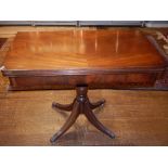 A Regency style mahogany card table, the rectangular fold over top on a turned support and moulded