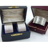 A pair of boxed silver napkin rings, together with a single boxed napkin ring, hallmarked Birmingham