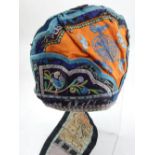 An early 20th century Chinese silk embroidery skull cap, the central panel with bats on an orange