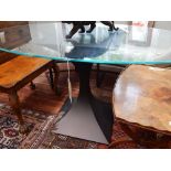 A contemporary glass top pedestal table, the oval top on a waisted square support, W. 157cm.