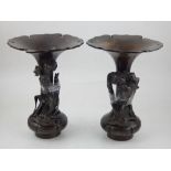 A pair of Meiji period bronze vases of trumpet form the bodies applied with flower stems, bears