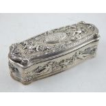 A white metal trinket box, repousse embossed with putti and foliage, gilt washed interior, stamped