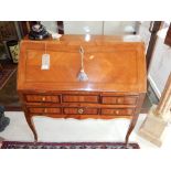 A 19th century French kingwood bureau, the shaped fall enclosing a stepped interior with a well