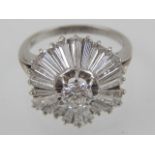 A diamond cluster ring with central brilliant cut stone surrounded by twenty four tapered