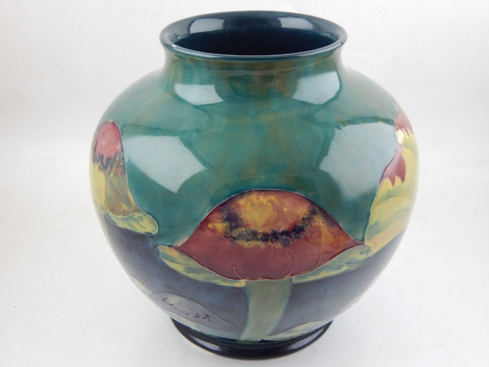 A large Moorcroft Claremont pattern baluster vase, the tube lined body on a mottled green blue