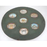 A collection of seven 19th century Indian oval miniatures on ivory, views of palaces, ruins and