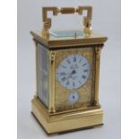 A French gilt brass repeating carriage clock, the white dial with Roman numerals covered by