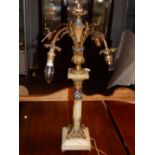 An early 20th century French gilt metal, champleve enamelled onyx four branch table lamp, with