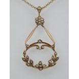 An Edwardian seed pearl pendant, in the form of a hoop set with foliage and flowers from a cluster