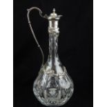 A modern Victorian style silver mounted cut glass claret jug, embossed with fruiting vines with cast