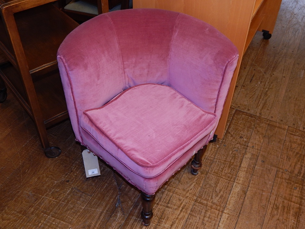 A Victorian corner chair, upholstered in pale red draylon, raised on turned feet. H.70cm, D.