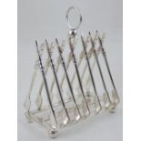 A silver plated six division toast rack, modelled as crossed rowing oars. H.