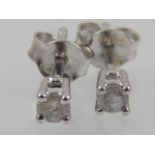 A pair of diamond ear studs, aprox. 0.33ct, claw set in white metal stamped 750, 1g.