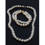 A cultured pearl strand with 14ct yellow gold clasp, together with a similar two strand bracelet.