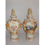 A pair of German style floral encrusted ceramic baluster vases, decorated with 18th century figures.