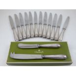 A set of twelve 20th century Christofle knives, with white metal shell cast handles, with a box,