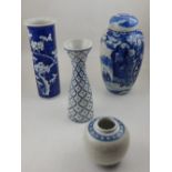 A blue and white Kangxi style porcelain tapered vase, decorated with flowers on a blue ground,