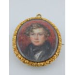 A 19th century yellow metal mounted pendant brooch, set portrait miniature,