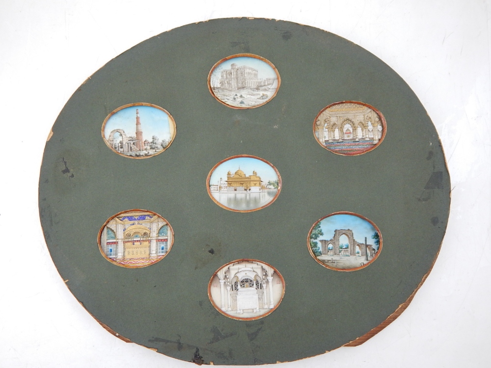 A collection of seven 19th century Indian oval miniatures on ivory, views of palaces, ruins,