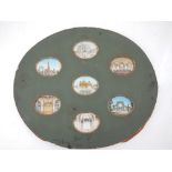 A collection of seven 19th century Indian oval miniatures on ivory, views of palaces, ruins,