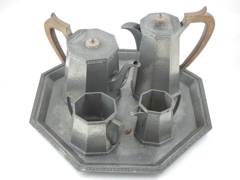 An Art Deco pewter tea service to include an octagonal tray, tea pot, coffee pot,