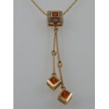 A 9ct gold, Mandarin garnet and diamond drop pendant, suspended on a 9ct gold chain.