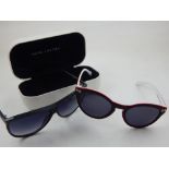 A pair of Marc Jacobs ladies sunglasses, boxed, together with a pair of Moschino ladies sunglasses.