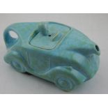 A teapot modelled as a racing car, by Sadler, in a mottled green glaze, W. 23cm.