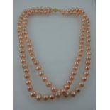 A pink cultured pearl two-strand choker necklace, with 14ct yellow gold filigree clasp.