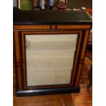 A late Victorian ebonised amboyna banded pier cabinet, enclosed by a glazed door. W.