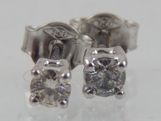 A pair of diamond ear studs, aprox 0.21ct, claw set in white metal stamped 750, 1g.