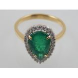 An 18 carat yellow gold, diamond, and emerald cluster ring, set pear cut emerald of 2.