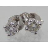 A pair of diamond ear studs, approx 0.3ct, claw set in white metal stamped 750, 1g.